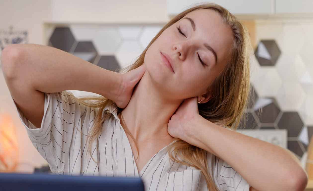 Lady having neck pain at office work desk